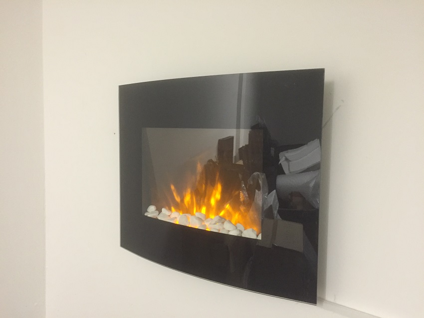 black glass small truflame wall mounted electric fire with pebbles and LEDs